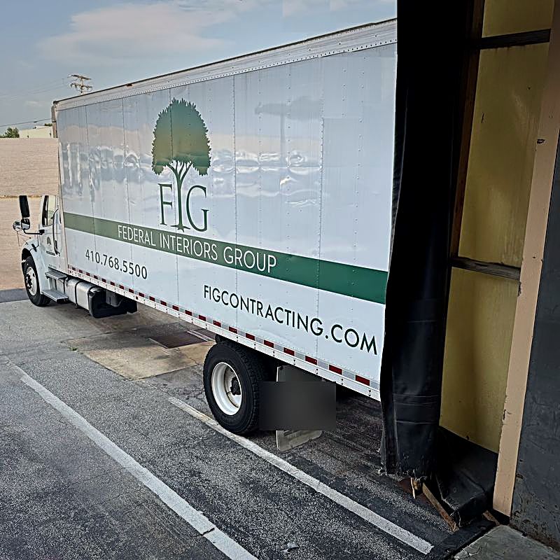 Federal Interiors Group branded delivery truck staged at the BWI hub loading dock