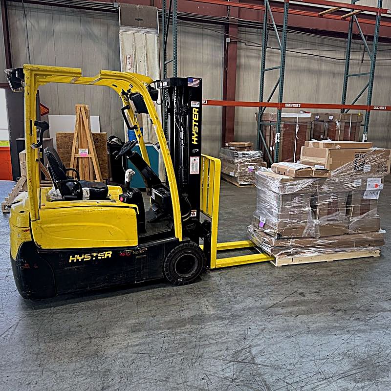 Forklift moving a wrapped pallet at the FIG BWI hub